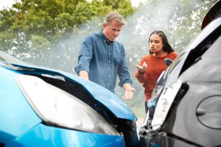 Two drivers discussing who is at fault after an accident.