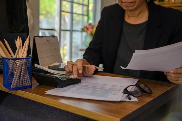 A person sitting at a desk reviewing financial documents