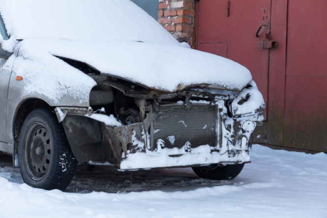 Snow covered damaged vehicle illustrating weather related collision in Houston, TX